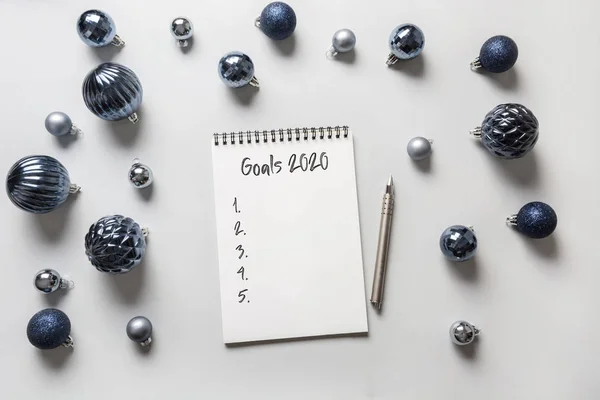 Wish list, checklist, to do list activity for New 2020 Year. Xmas. Christmas invitation. View from above. Flat lay. Gift expense planning. Classic blue Holiday decor.