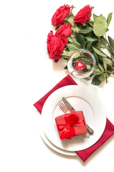 Romantica tavola apparecchiata con bouquet di rose rosse e regalo. Vista dall'alto. San Valentino . — Foto Stock