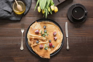 Traditional russian breakfast pancakes, coffee, honey. Springtime. Shrovetide.