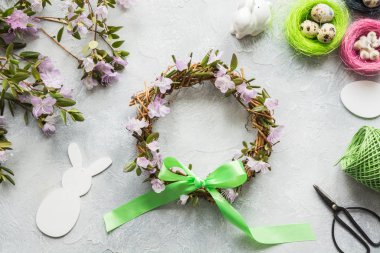 Spring wreath with flowers on light. Creative flat lay. Decor handmade.