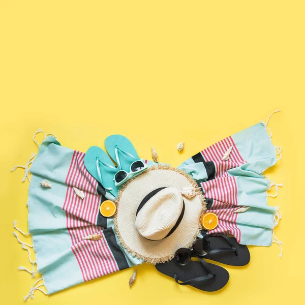 Outfit for beach tropical vacations, straw sun hat, towel, sun glasses on yellow. Summer concept. Top view. — ストック写真