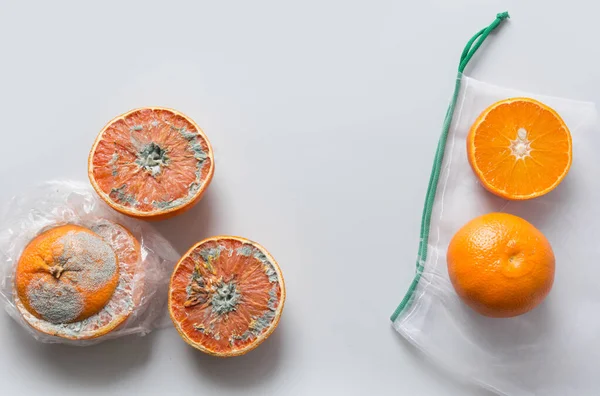 Comparison of food storage in plastic and mesh bag on example of an orange. Invalid storage.