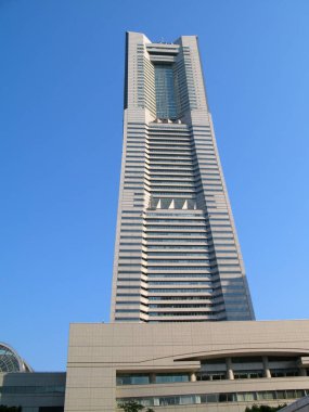 Yokohama, Kanto Region, Japan - April 30, 2009: Bottom view of facade of Yokohama Landmark Tower building under clear blue sky in Minato Mirai 21 district in Japanese Yokohama city. In the building are five-star hotel, offices, restaurants, shops. 