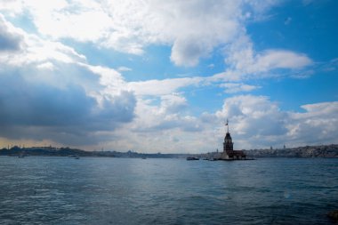 İstanbul Boğazı 'nda yüzen turist tekneli Maiden Tower veya Kiz Kulesi. İstanbul 'un tarihi işareti Bakire Kulesi