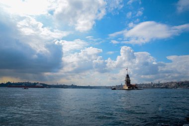 İstanbul Boğazı 'nda yüzen turist tekneli Maiden Tower veya Kiz Kulesi. İstanbul 'un tarihi işareti Bakire Kulesi