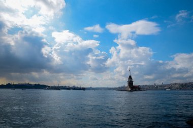 İstanbul Boğazı 'nda yüzen turist tekneli Maiden Tower veya Kiz Kulesi. İstanbul 'un tarihi işareti Bakire Kulesi