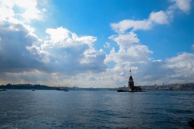 İstanbul Boğazı 'nda yüzen turist tekneli Maiden Tower veya Kiz Kulesi. İstanbul 'un tarihi işareti Bakire Kulesi
