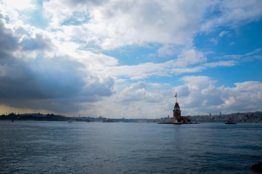 İstanbul Boğazı 'nda yüzen turist tekneli Maiden Tower veya Kiz Kulesi. İstanbul 'un tarihi işareti Bakire Kulesi