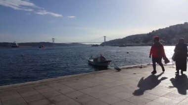 Video taken on 8th March: 2020:  Young man riding electric scooter through coastal path. Modern transportation gadget and popular futuristic device among young people