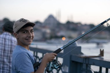 Fotoğraf 28 Haziran 2018 'de çekildi: İstanbul' daki Galata Köprüsü 'nde küçük balıkçılar balık tutuyor