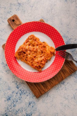 Italian cuisine: lasagna made of pasta, minced meat, tomatoes, cheese, spices.