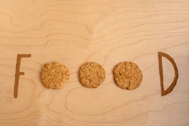 Creative bright writing on the table made from cookies and cinnamon