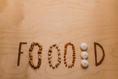 Creative bright writing on the table made from nuts and cinnamon
