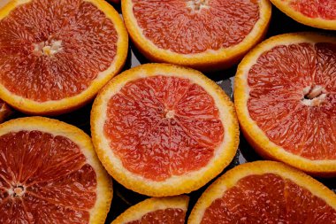 Pieces of red orange on a black background close-up