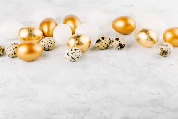 Telur emas Paskah yang dilukis dan telur puyuh dengan latar belakang marmer . — Stok Foto