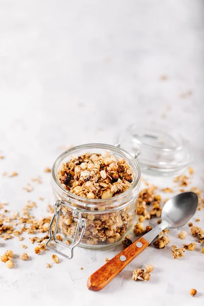 Homemade granola with nuts and seeds in glass jar for healthy breakfast — Stock Photo, Image