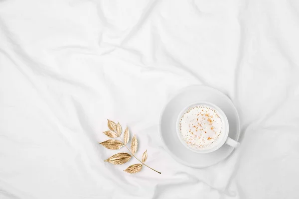 Cup of coffee on bed — Stock Photo, Image