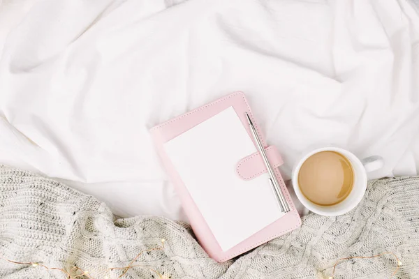 Notizbuch und Tasse auf dem Bett — Stockfoto