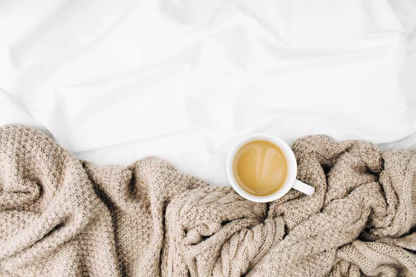 Cup of coffee in scarf — Stock Photo, Image