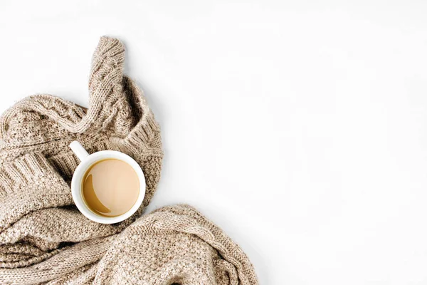 Cup of coffee in scarf — Stock Photo, Image