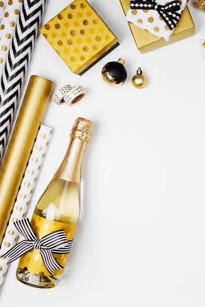 Flat Lay Champagne Bottle Presents Golden Wrapping Paper Rolls White — Stock Photo, Image