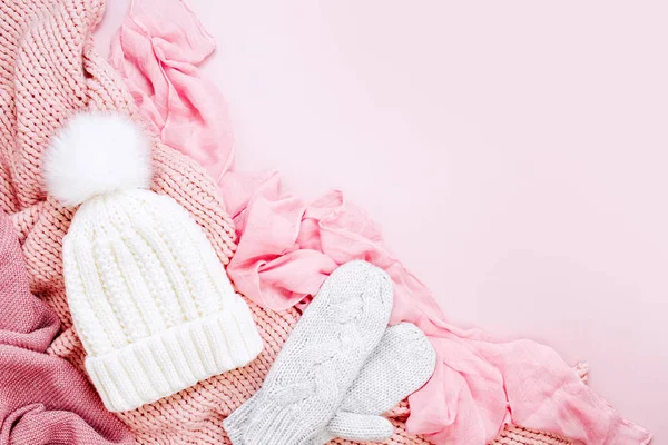 warm winter clothes and pastel pink Christmas decor