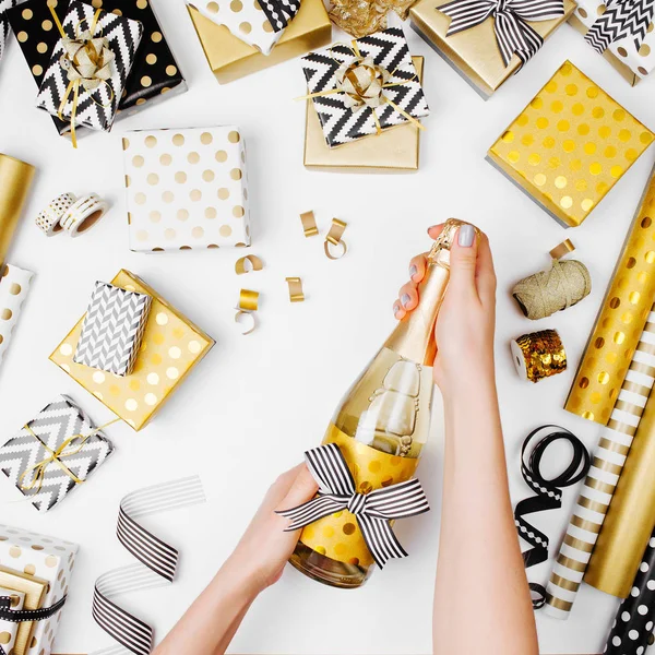 Female Hands Opening Champagne Bottle Table Flat Lay Golden Presents — Stock Photo, Image