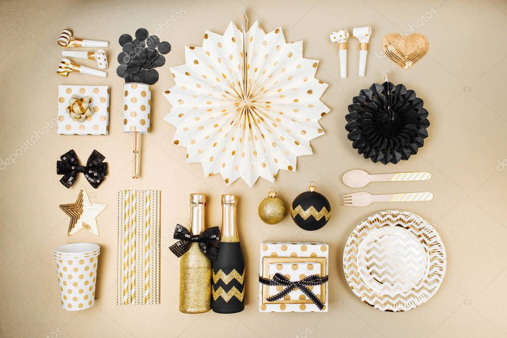 table setting decorated with Christmas balls and stuff in golden and black colors, flat lay
