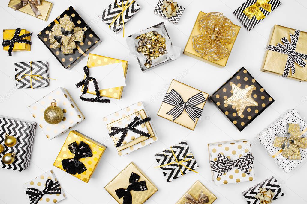 Christmas Background with Gift boxes, Ribbons, Decorations in Gold and Black colors 