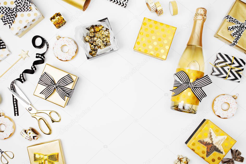 Christmas set with gift boxes, champagne bottle, bows, decorations in golden and black colors