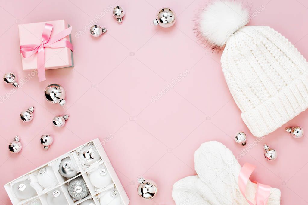 Top view of christmas decorations, gift box and hat with gloves isolated on pink background 