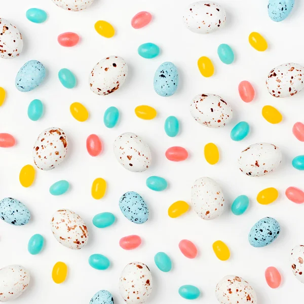 Pattern with Easter candy chocolate eggs and Jellybean on white background