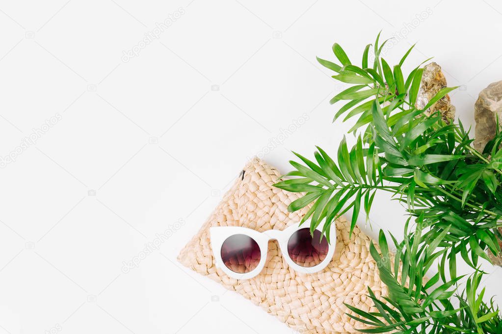 Tropical leaves and Beach bag with sunglasses  on  white  background. Top view, flat lay.