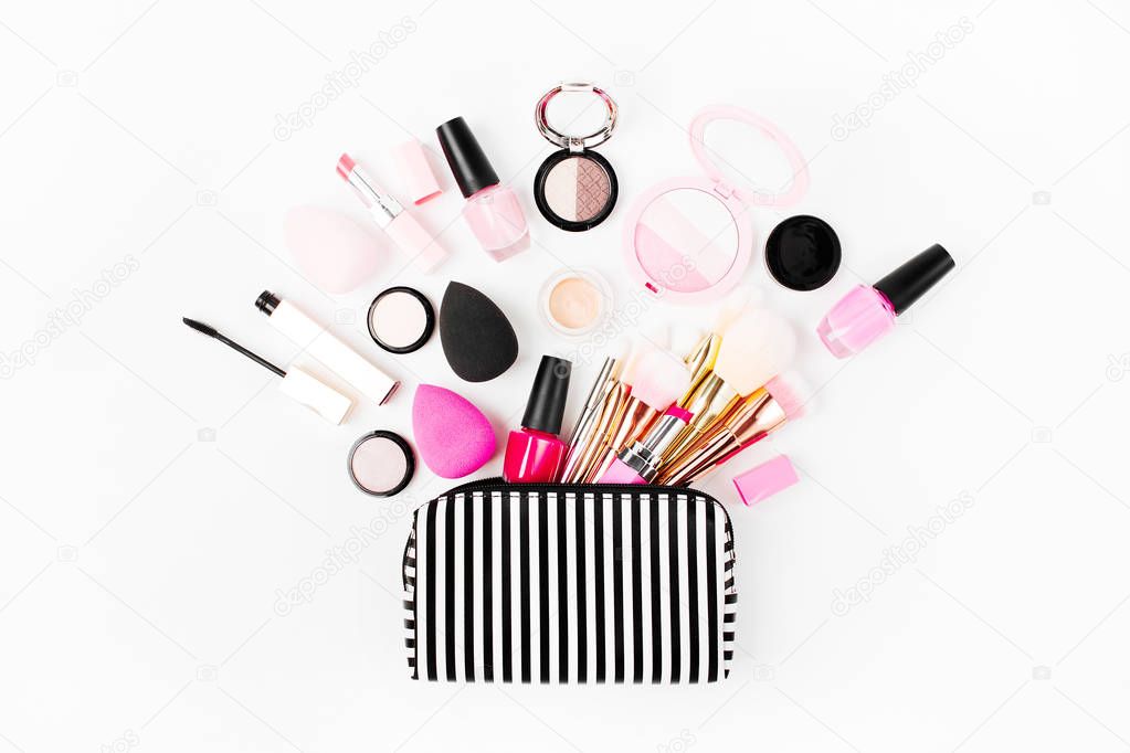 Cosmetic bag with beauty accessory and makeup product. Top view, copy space.
