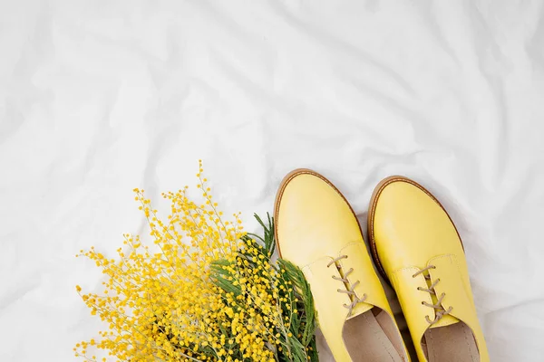 Flat lay with mimosa flowers and stylish yellow shoes, spring concept — Stock Image Flat Lay Mimosa Flowers Stylish Yellow Shoes Spring Concept Royalty Free Stock Photos