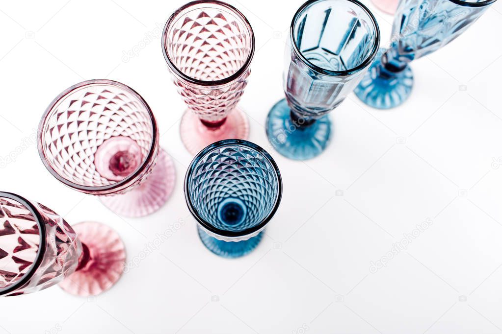 Colored Vintage Goblets for wine or champagne isolated on white background. Top view, flat lay.