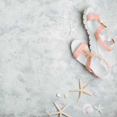 Pembe kadın yaz ayakkabı, grunge zemin üzerine starfishes ile şık arka plan.