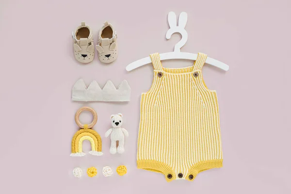 Set Baby Clothes Accessories Pink Background Yellow Knitted Romper Cute — Stok fotoğraf