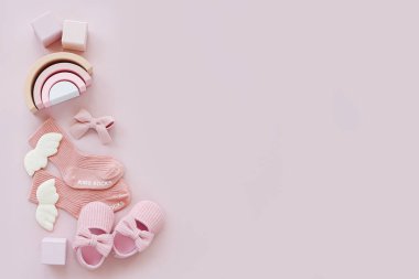 Pink socks, shoes and toys. Set of baby stuff and accessories for girl on pastel background. Baby shower concept.  Fashion newborn. Flat lay, top view
