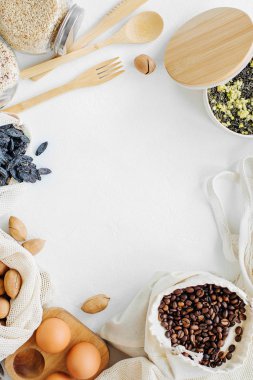 Reusable mesh produce bags full of nuts and dried fruits.  Glass jars with groats. Zero Waste Food Shopping.  Waste-free living