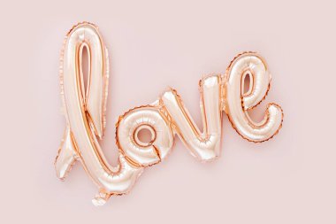 Pale pink Foil Balloons in the shape of the word 