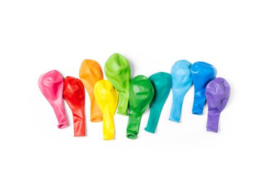Row of rainbow colored balloons on white background. Festive concept. Flat lay, top view.