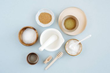 Beauty treatment ingredients for making homemade skin care cosmetic mask. Various bowl with clay, cream, essential oil and natural ingredients  on white table background. Organic spa cosmetic products