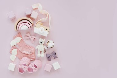 Set of baby stuff and accessories for girl on pastel background. Pink socks, shoes and toys. Baby shower concept.  Fashion newborn. Flat lay, top view