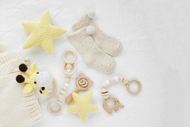 Oyuncak zürafa, sarı yıldızlar ve yeni doğan bebek için tahta ip. Cinsiyet ayrımı olmayan bebek eşyaları ve aksesuarlar. Düz yatış, üst görünüm