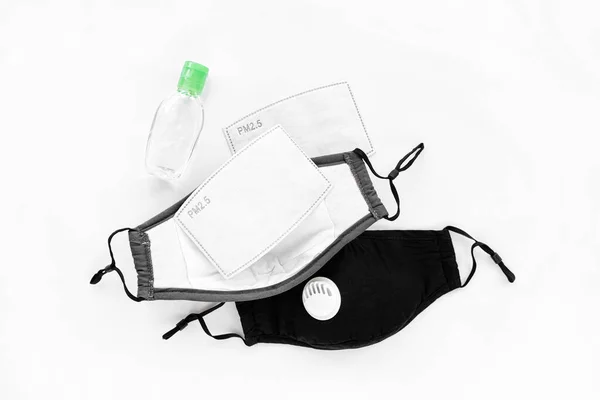 Reusable antiviral masks with breather filter valve and hand sanitizer. Cotton  masks with activated carbon filter.  Protection against flu and coronavirus, pollution, virus. Personal hygiene products.