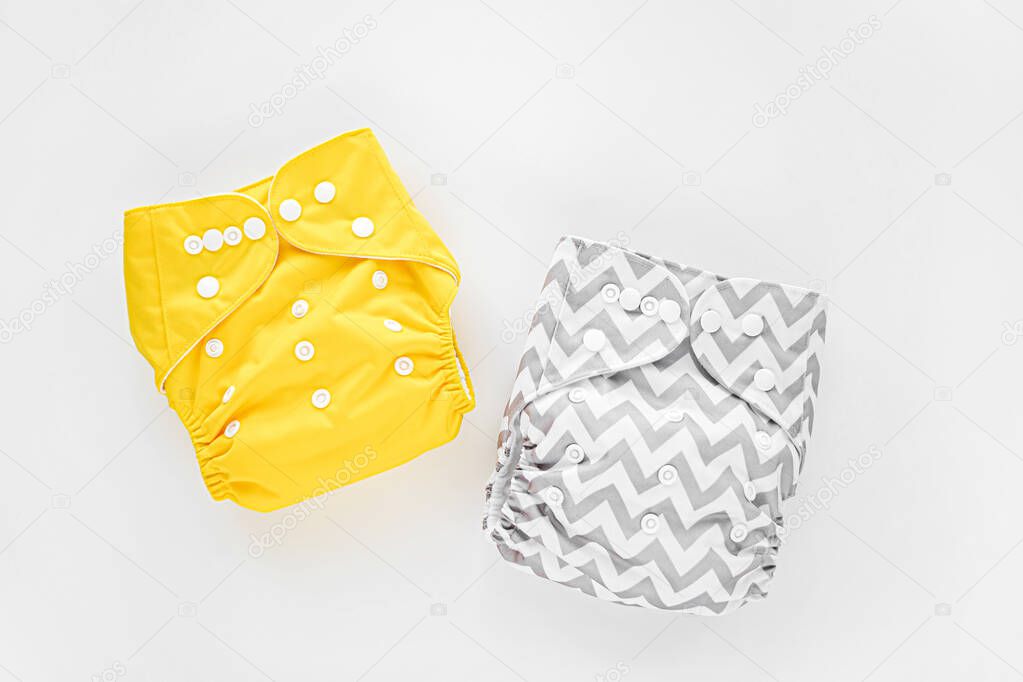 Reusable cloth baby diapers. Eco friendly cloth nappies on a white background. Sustainable lifestyle.  Zero waste concept. 
