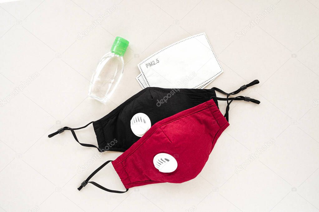 Reusable antiviral masks with breather filter valve and hand sanitizer. Cotton  masks with activated carbon filter.  Protection against flu and coronavirus, pollution, virus. Personal hygiene products.  