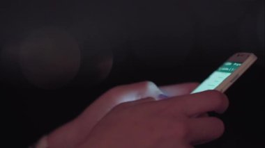 Gece akıllı telefon kullanan Brezilyalı bir kadın.