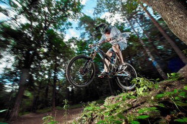 Moscow, Rusya Federasyonu - 21 Ağustos 2017: Atlama ve dağ bisikleti üzerinde uçmak. Binici dağ bisiklet spor eylem. Ormanda sürme motorcu. Serin atlet bisikletçi bir bisiklet. Mtb bisikleti.